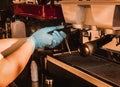 Barista holding portafilter making espresso coffee at the cafe at the coffee machine. Coronavirus situation. Royalty Free Stock Photo