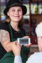 Barista holding smart phone with coupon code