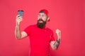 Barista job position. Cheerful barista. Man bearded hipster red cap uniform hold paper coffee cup. Barista recommend Royalty Free Stock Photo