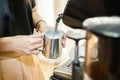 Barista make a cappuccino or latte steaming and frothing milk Royalty Free Stock Photo