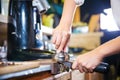 Barista make coffee espresso shot by streaming machine in coffee cafeteria bar.