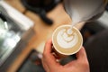 Barista make coffee latte art with coffee espresso machine in coffee shop cafe, top view. Morning aroma coffee lifestyle Royalty Free Stock Photo