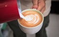 Barista make latte art. Cup of coffee latte.