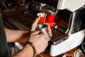 Barista makes coffee on a professional coffee machine in a cafe.