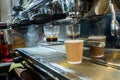 Barista makes fresh and tasty coffee on a coffee machine