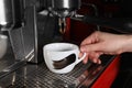 Barista making aromatic espresso using professional coffee machine in cafe, closeup Royalty Free Stock Photo