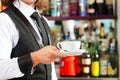 Barista making cappuccino in his coffeeshop