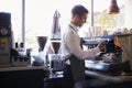 Barista Making Coffee In Delicatessen Using Machine Royalty Free Stock Photo