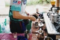 Barista making coffee in a kitchen at outdoors