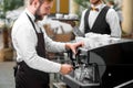 Barista making coffee with waiter Royalty Free Stock Photo