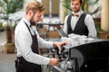 Barista making coffee with waiter Royalty Free Stock Photo