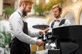 Barista making coffee with waiter Royalty Free Stock Photo