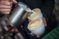 Barista making 2 cups of cappuccino at once