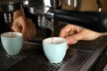 Barista making espresso using professional coffee machine, closeup Royalty Free Stock Photo