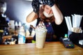 Barista making frappe - iced latte coffee with caramel and chocolate syrup and whipped cream Royalty Free Stock Photo