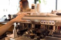 Barista making fresh espresso shot from coffee machine with customer in background Royalty Free Stock Photo