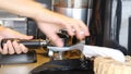 Barista Making Ground Coffee With Coffee Grinder