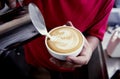 Barista making latte or Cappuccino art with frothy foam, coffee