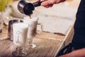 Barista making latte , hands and cups in the picture