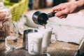 Barista making latte , hands and cups in the picture