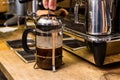 Barista making non traditional coffee in french press Royalty Free Stock Photo