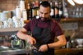 Barista man making espresso at bar or coffee shop