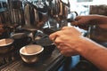 Barista man making two cups of coffee drink at the same time using professional coffee machine in cafe Royalty Free Stock Photo