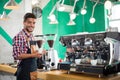 Barista offering a cup of coffee to camera in a cafe Royalty Free Stock Photo