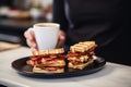 barista pairs a coffee cup with a crispy bacon sandwich