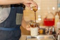 Barista pouring coffee to takeaway cup to making iced coffee latte in the cafe. Royalty Free Stock Photo