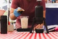 Barista pouring espresso shot into a glass of cold fresh milk. Royalty Free Stock Photo