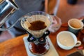 Barista pouring hot water in paper filter with grind coffee Royalty Free Stock Photo