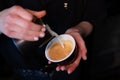 Barista pouring latte foam on coffee, espresso. creating a perfect latte art. dark colours, coffee house Royalty Free Stock Photo