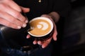 Barista pouring latte foam on coffee, espresso. creating a perfect latte art. dark colours, coffee house Royalty Free Stock Photo