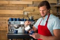 Barista pouring milk into cup at coffee shop Royalty Free Stock Photo