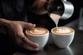 Barista pouring milk into a cup of latte art coffee. A coffee cup in a close up, A coffee cup in a close up, held by a baristas