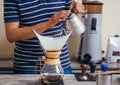 Barista pouring water on coffee with filter Royalty Free Stock Photo