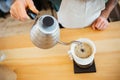 Barista pouring water on coffee ground with filter Royalty Free Stock Photo