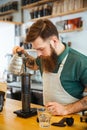 Barista pouring water on coffee ground with filter Royalty Free Stock Photo