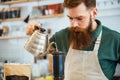 Barista pouring water on coffee ground with filter Royalty Free Stock Photo