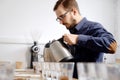 Barista pouring water to coffee cups Royalty Free Stock Photo