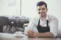 Barista prepares cappuccino in his coffee shop. Royalty Free Stock Photo