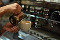 Barista prepares coffee latte. Against the background of a coffee machine.