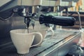 Barista prepares espresso in his coffee shop with machine Royalty Free Stock Photo