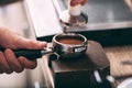 Barista pressing coffee in the machine holder Royalty Free Stock Photo