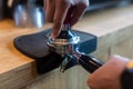 Barista pressing coffee in the machine holder. Coffee powder on coffee tamper. barista using tamper to press ground coffee into po Royalty Free Stock Photo