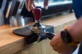 Barista pressing coffee in the machine holder. Coffee powder on coffee tamper. barista using tamper to press ground coffee into po Royalty Free Stock Photo