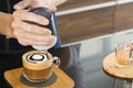 Barista's hands holding and pouring chocolate for prepare cup of coffee  latte art Royalty Free Stock Photo