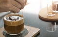 Barista's hands holding and pouring chocolate for prepare cup of coffee  latte art Royalty Free Stock Photo