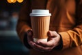 Barista serves a takeaway paper cup of steaming coffee gracefully